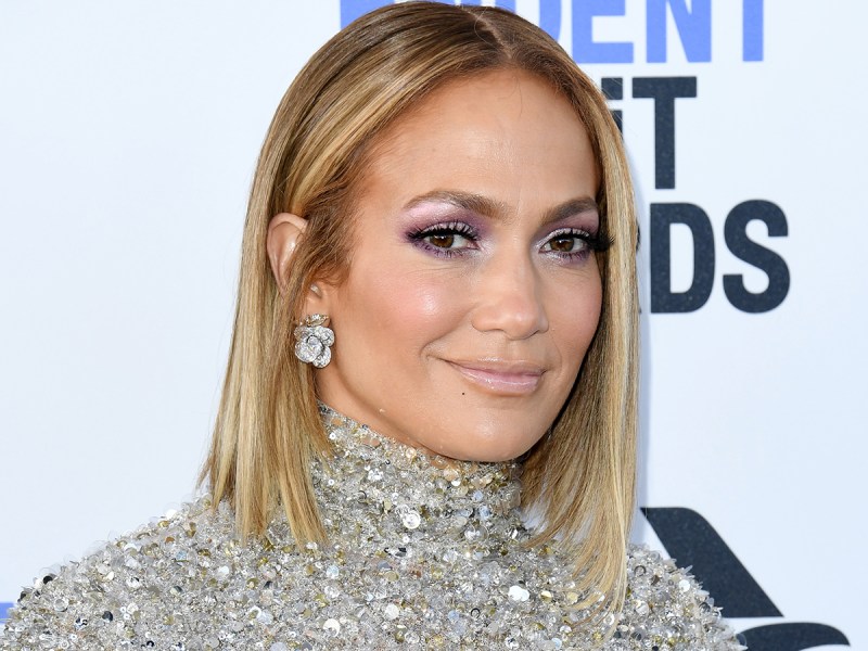 Close up of Jennifer Lopez smiling, with short-ish hair.