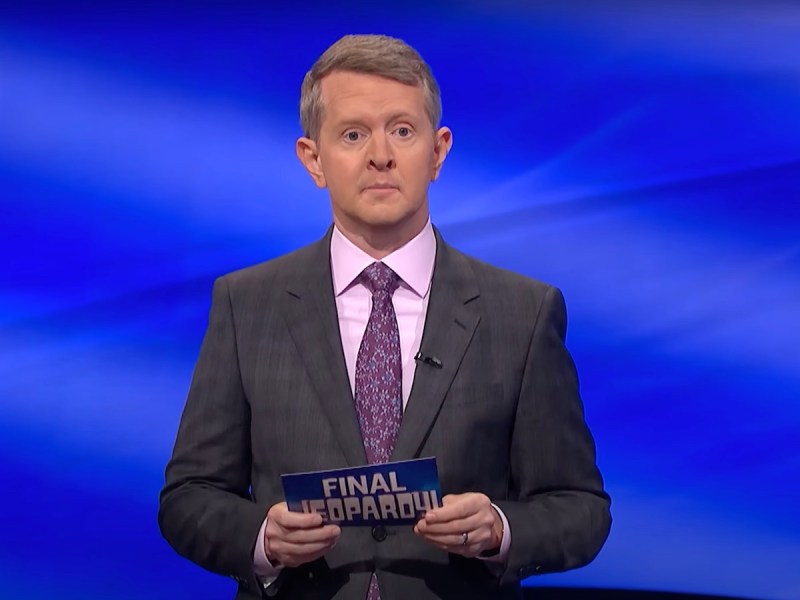 screenshot of Ken Jennings hosting Final Jeopardy in a grey suit and pink shirt and tie