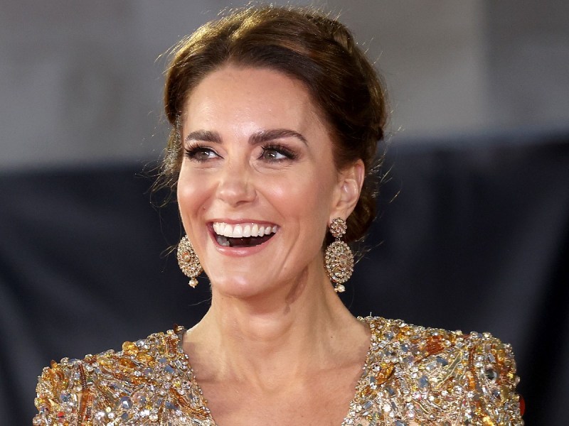 Kate Middleton smiles in gold dress with matching earrings
