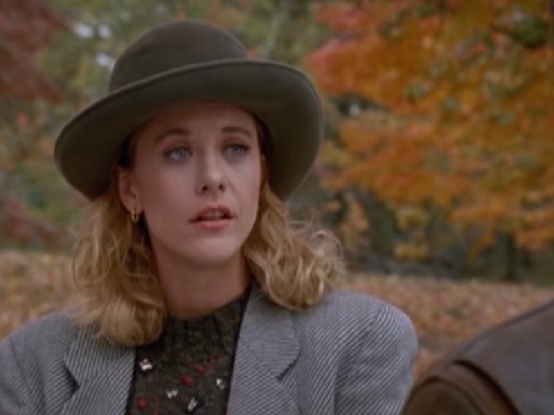 Screecap from "When Harry Met Sally," Meg Ryan wearing coat and hat standing in front of autumn trees
