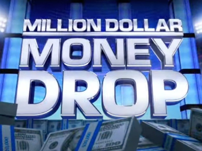 Large white text says "Million Dollar Money Drop" against a blue backdrop and stacks of cash