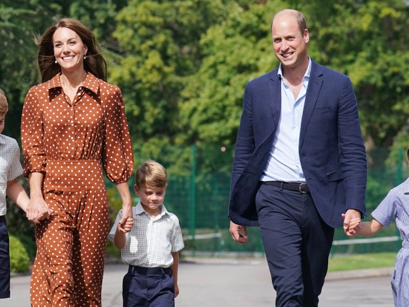 Prince Louis (middle) with Kate Middleton holding his hand on the left, and Prince William on the right