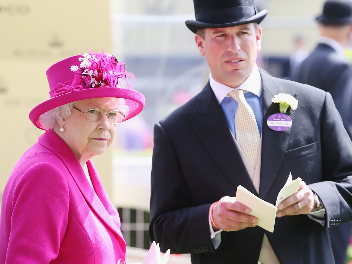 Queen Elizabeth (L) in fuschia outfit standing next to Peter Philips, who is wearing a suit and tie and matching hat