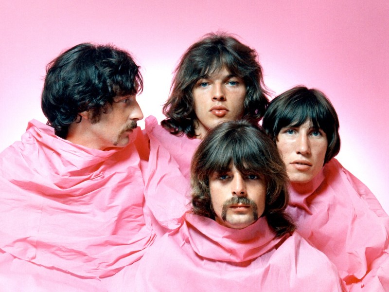 1968 photo of the members of Pink Floyd draped in a pink cloth against a pink background with only heads exposed