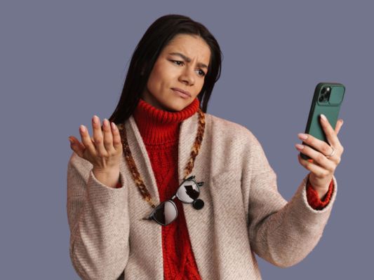 Woman looking unhappily at phone