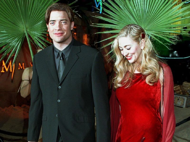 Young Brendan Fraser (L) with his then-wife Afton Smith (R), who is wearing red dress