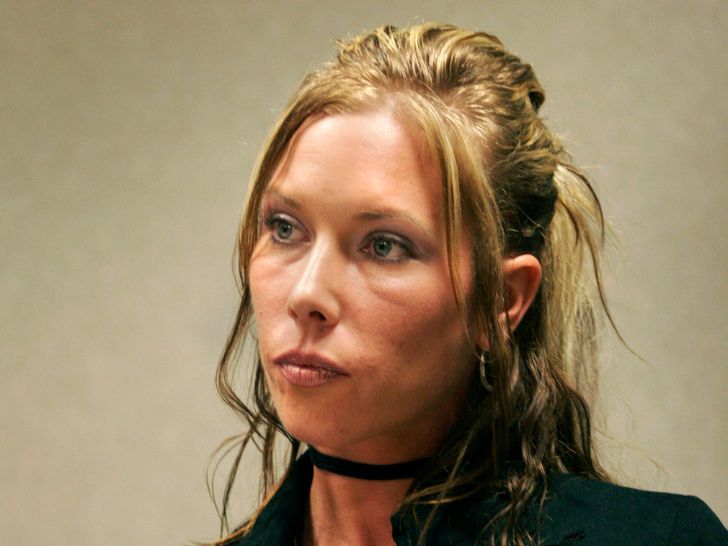 Eminem's ex-wife, Kimberly Anne Scott, in a dark green jacket and black choker necklace