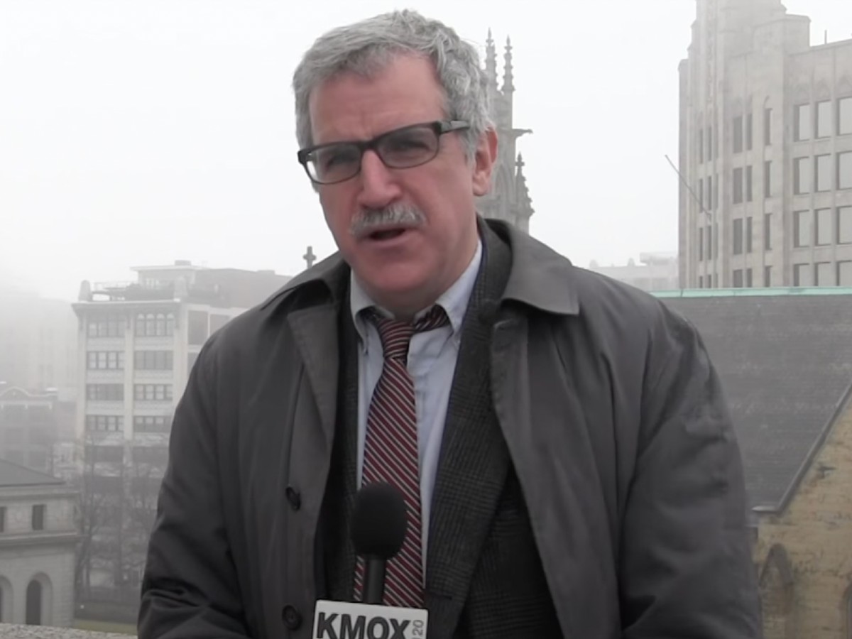 Kevin Killeen speaks into news microphone while standing outside