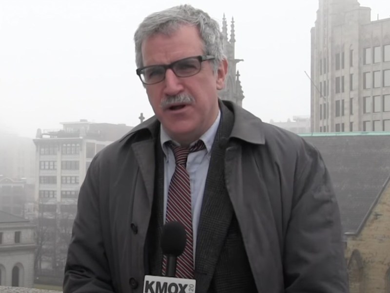 Kevin Killeen speaks into news microphone while standing outside