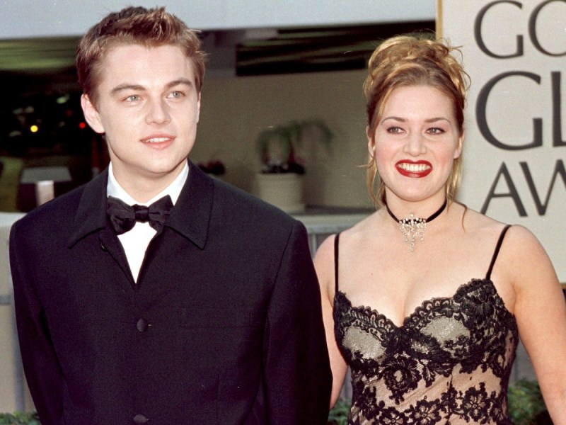 Leonardo DiCaprio (L) and Kate Winslet smiling in 1998
