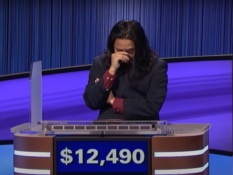 screenshot of Lloyd Sy during Final Jeopardy crossing his arms and covering his face with one hand