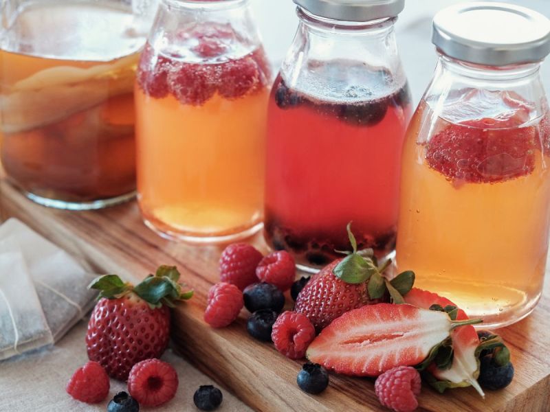Jars of kombucha with various fruit flavorings