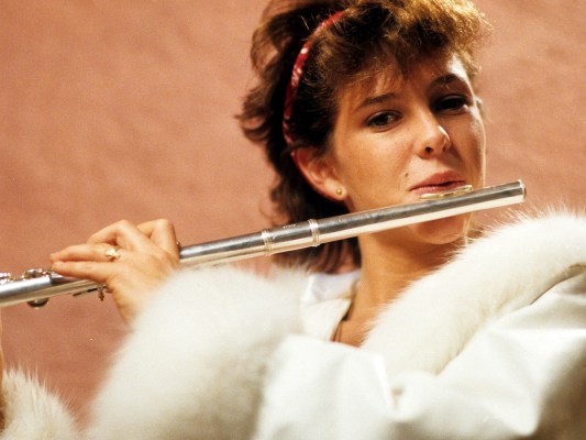 photo of Kristy McNichol in a white outfit playing a silver flute in 1984's Just The Way You Are