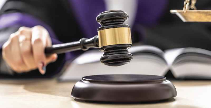 Judge Hitting Gavel On Wood