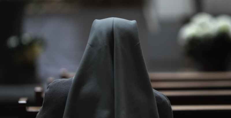 Nun Sitting In Church Chair