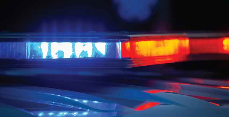 Police Car Flashing Lights At Crime Scene Investigation