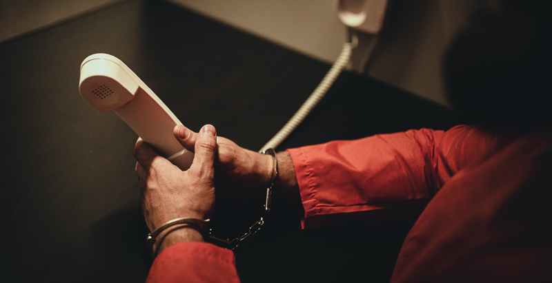 Prison Inmate Holding Phone