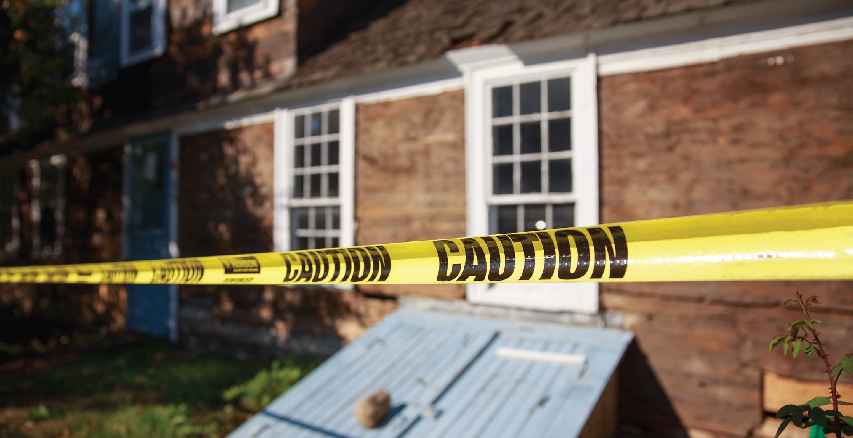 Yellow Caution Tape In Front Of House