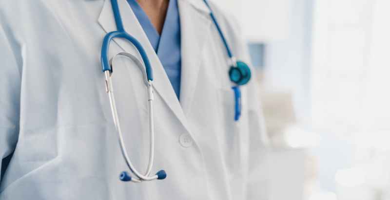 Doctor In Gown With Stethoscope