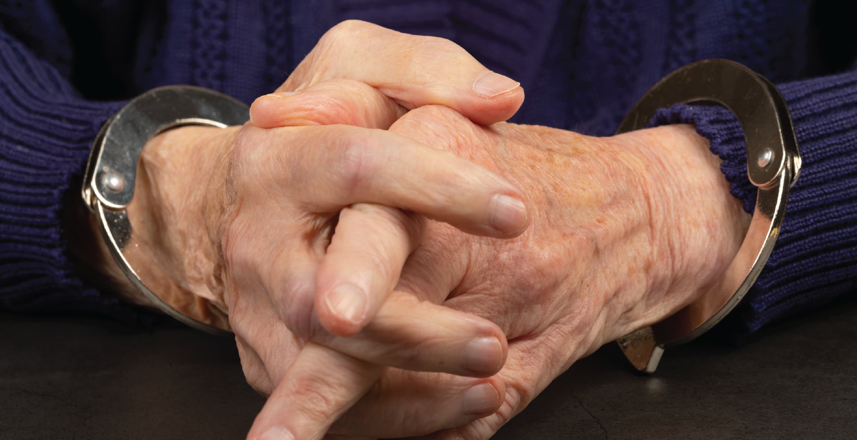 Elderly Woman In Handcuffs