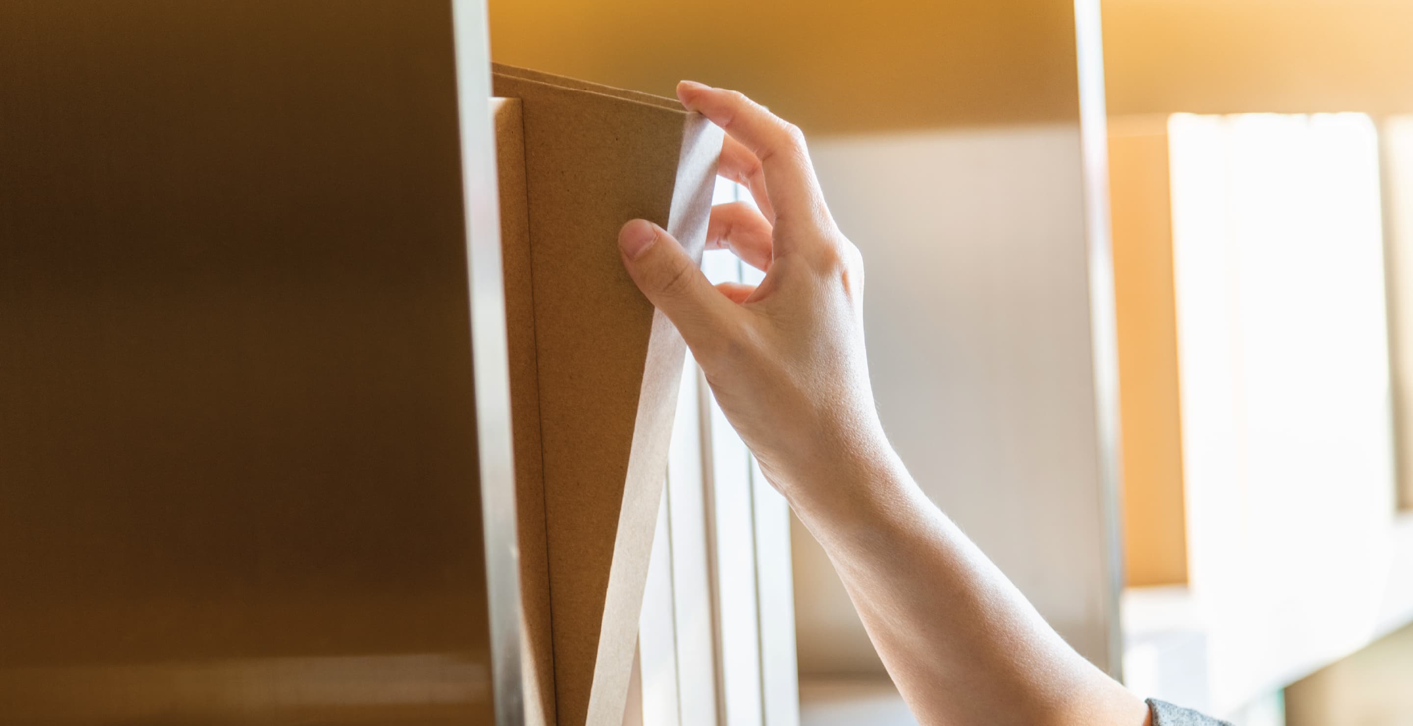 Hand Choosing Book From Bookshelf