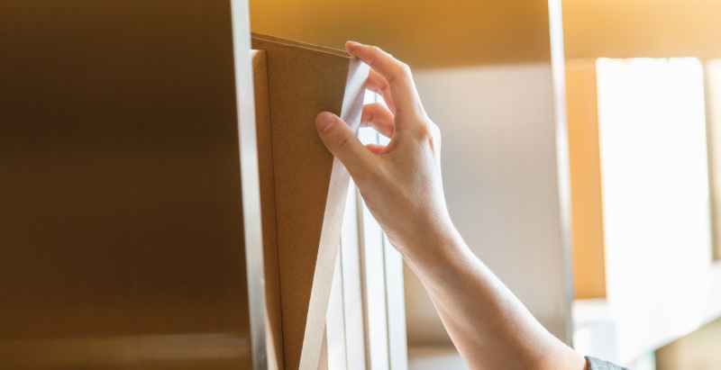 Hand Choosing Book From Bookshelf