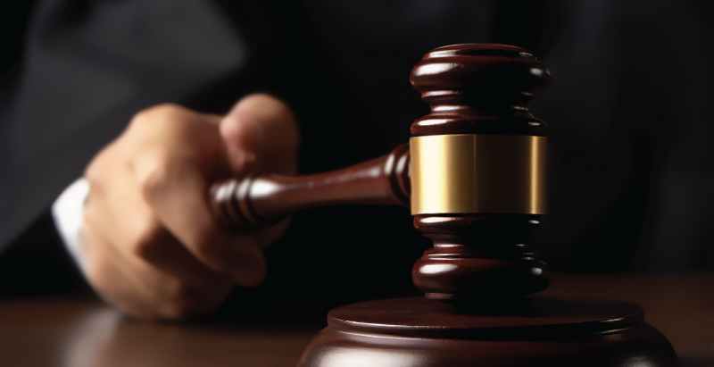 Judge Holding Gavel In Courtroom