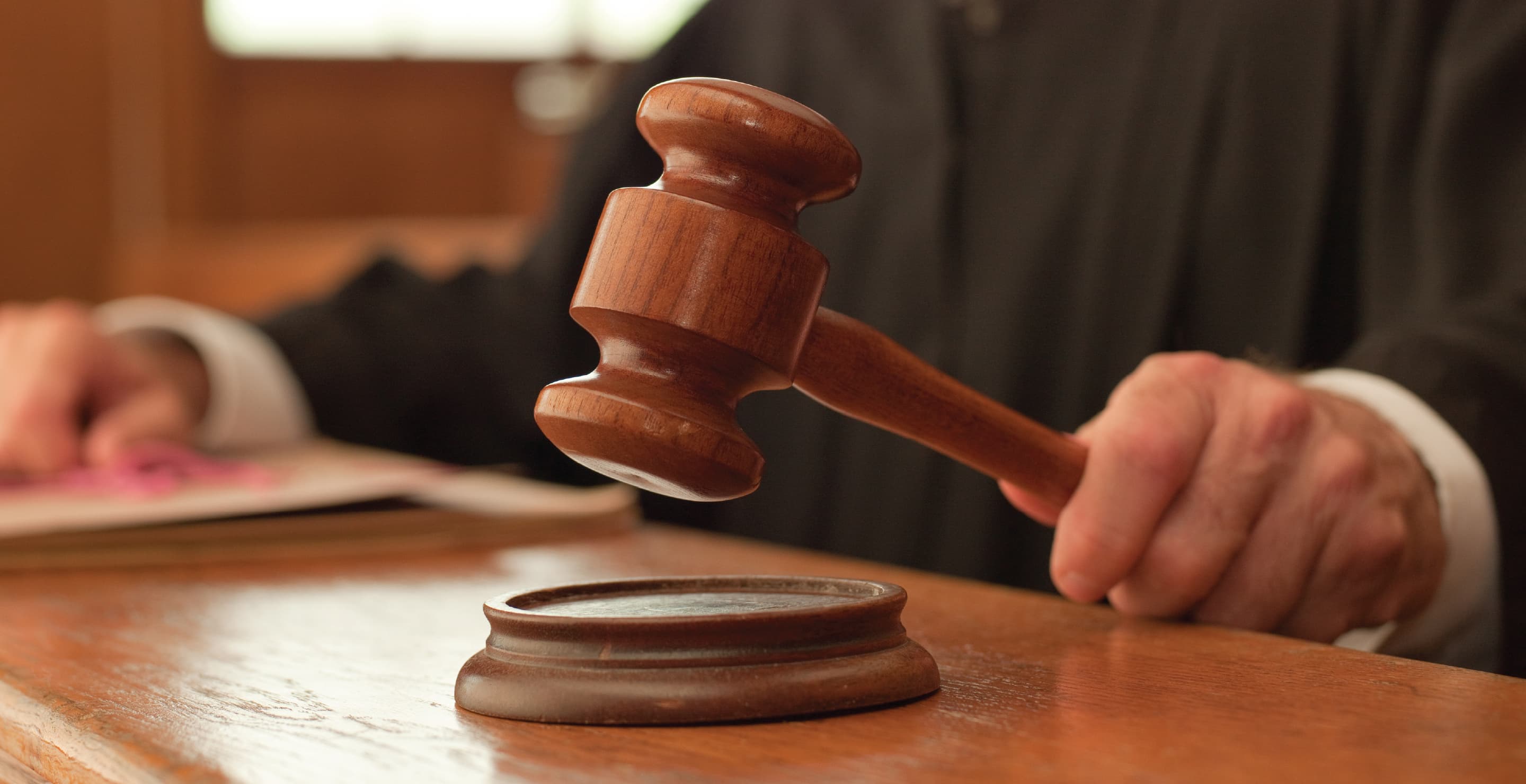Judge Holding Gavel In Courtroom