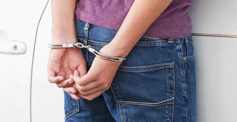 Man In Handcuffs Against Car