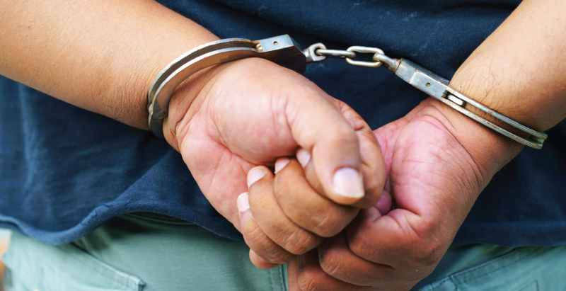 Man In Handcuffs With Hands Behind