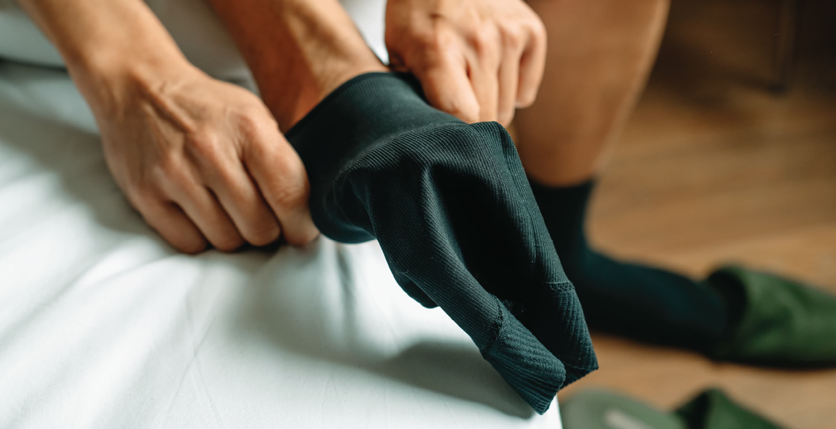 Man Putting On Black Socks