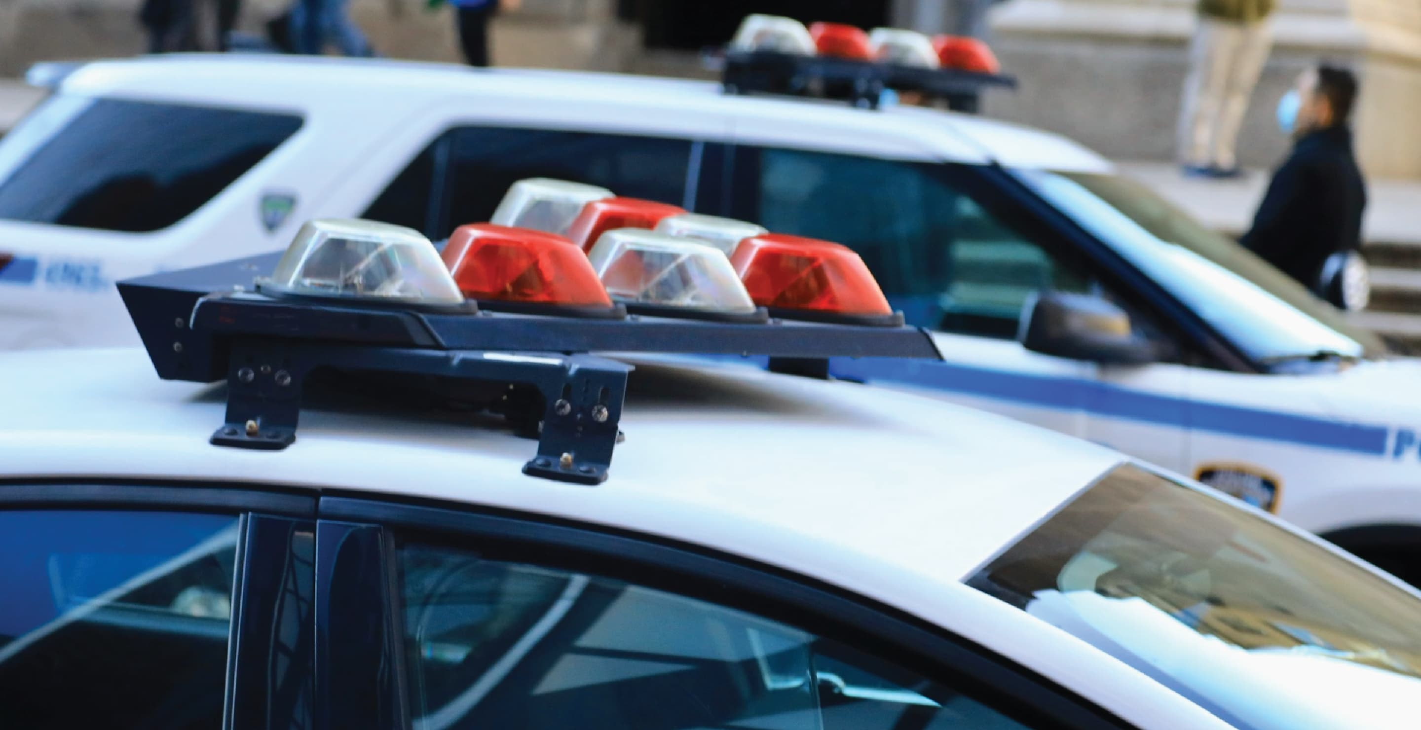 Police Patrol Cars At Crime Scene, Day