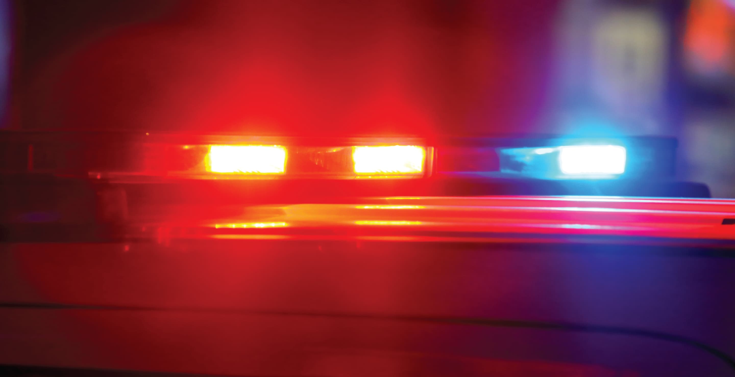 Police Vehicle Responding To Crime Scene With Flashing Lights