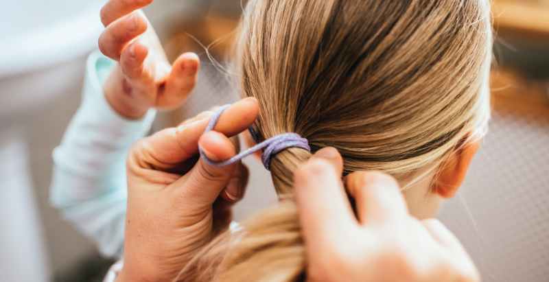 Woman Fixing Girl's Hair
