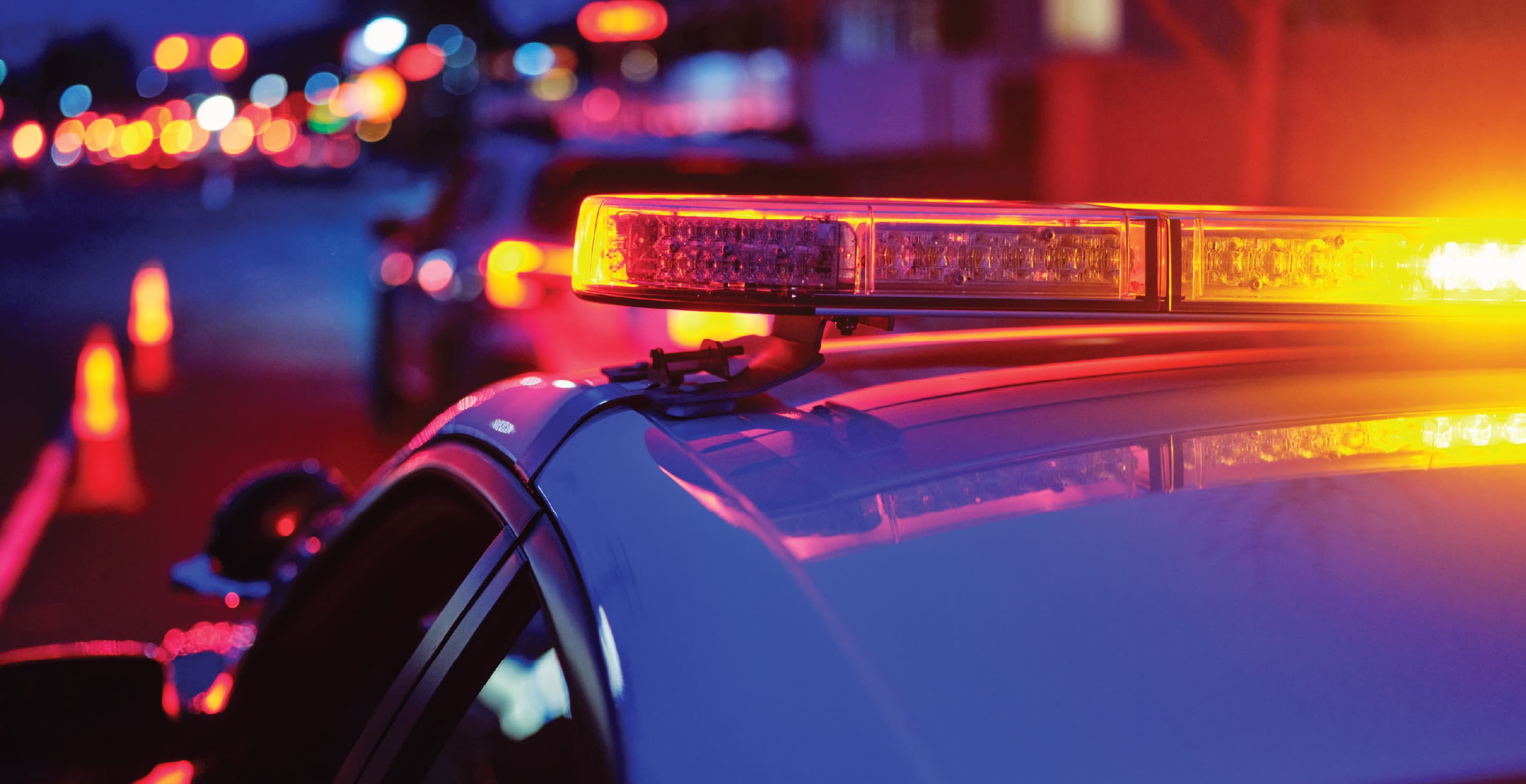 Police Car At Night With Emergency Lights