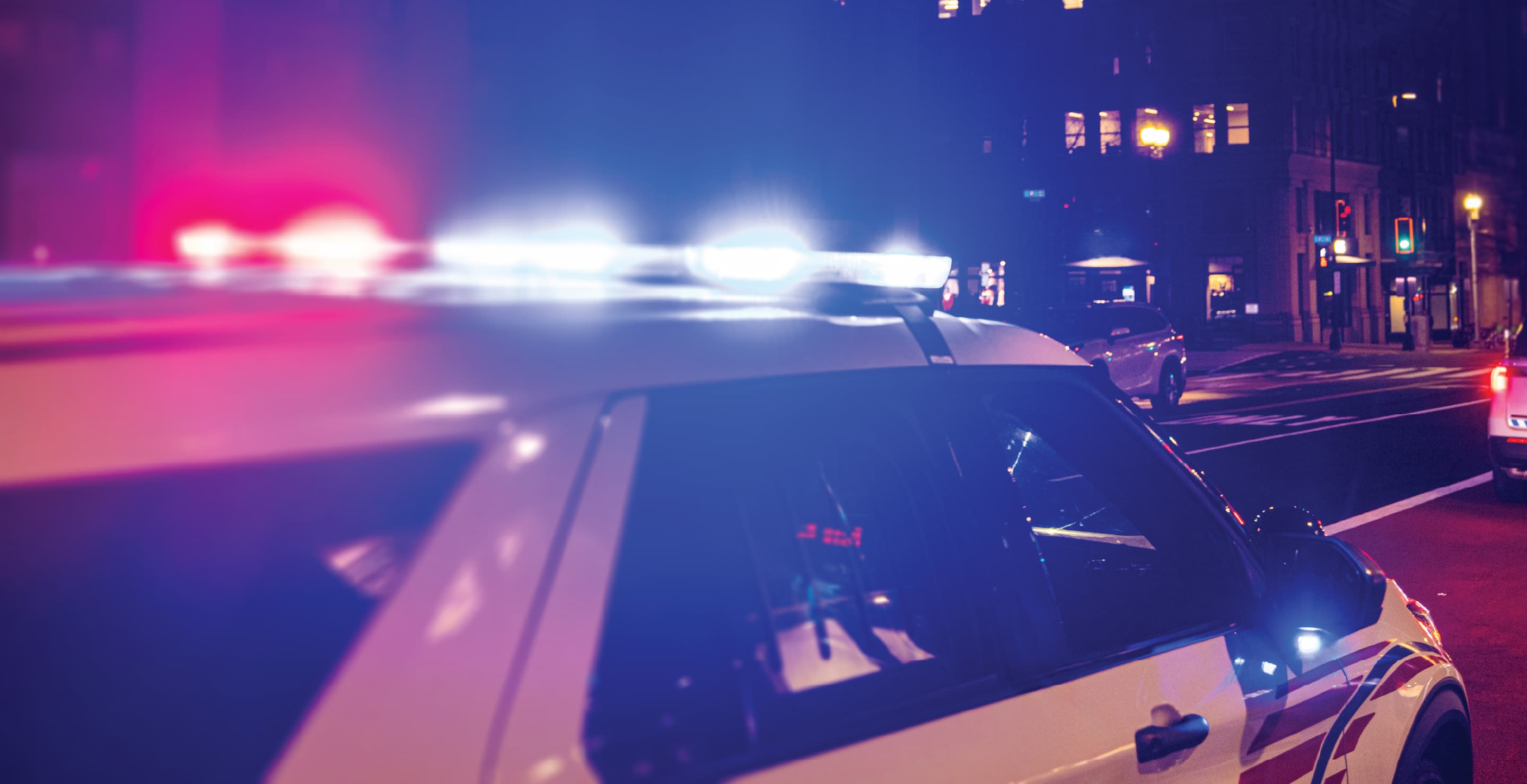 Police Car With Lights On At Night